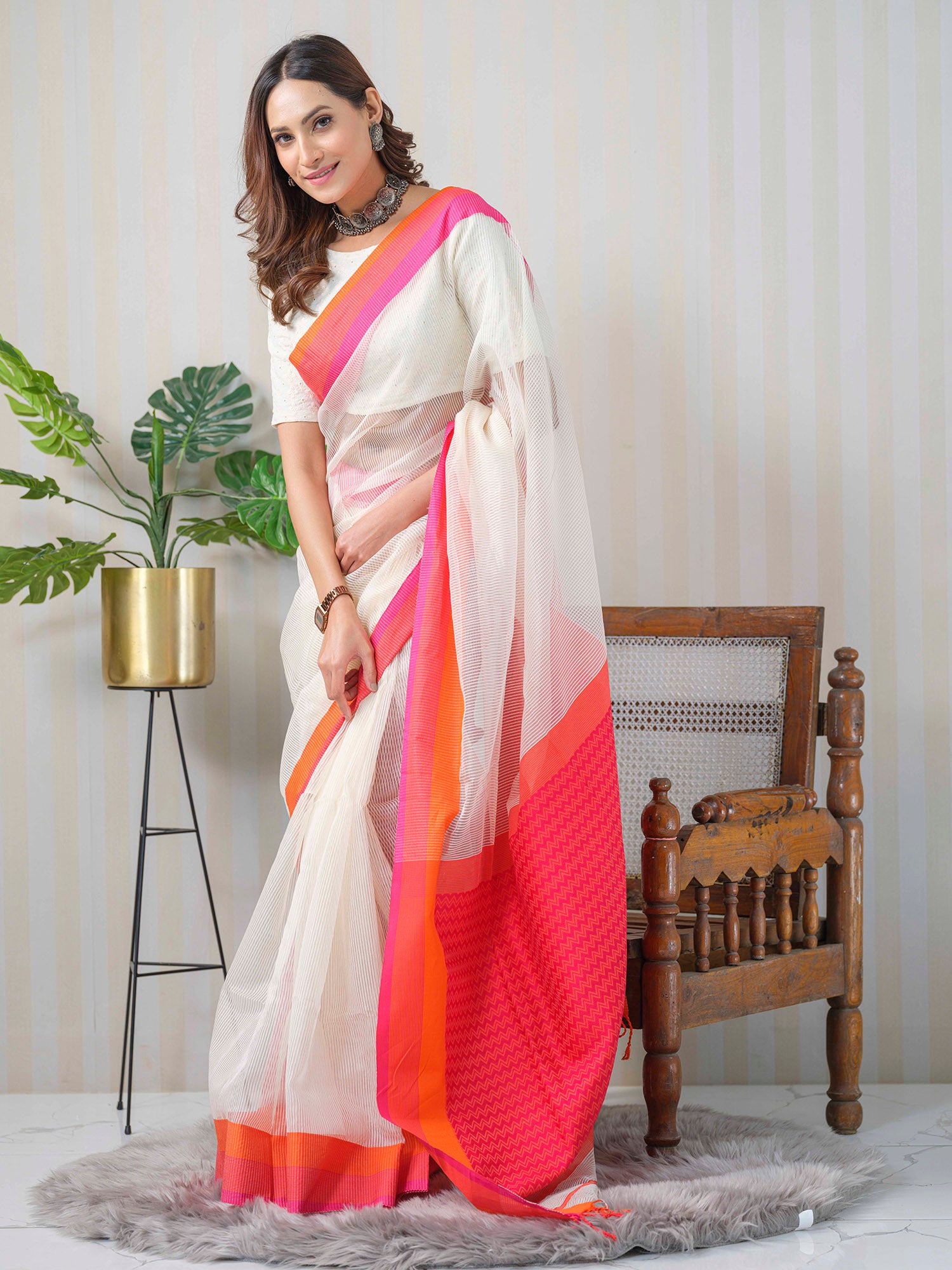 White and neon pink Maheshwari linen and silk saree.