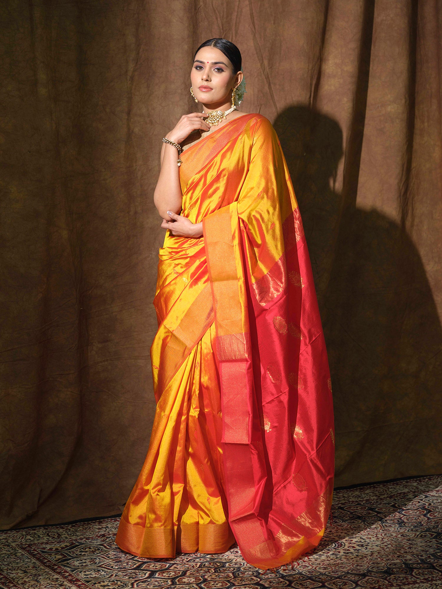 Mustard Yellow Maheshwari silk saree with red accents.
