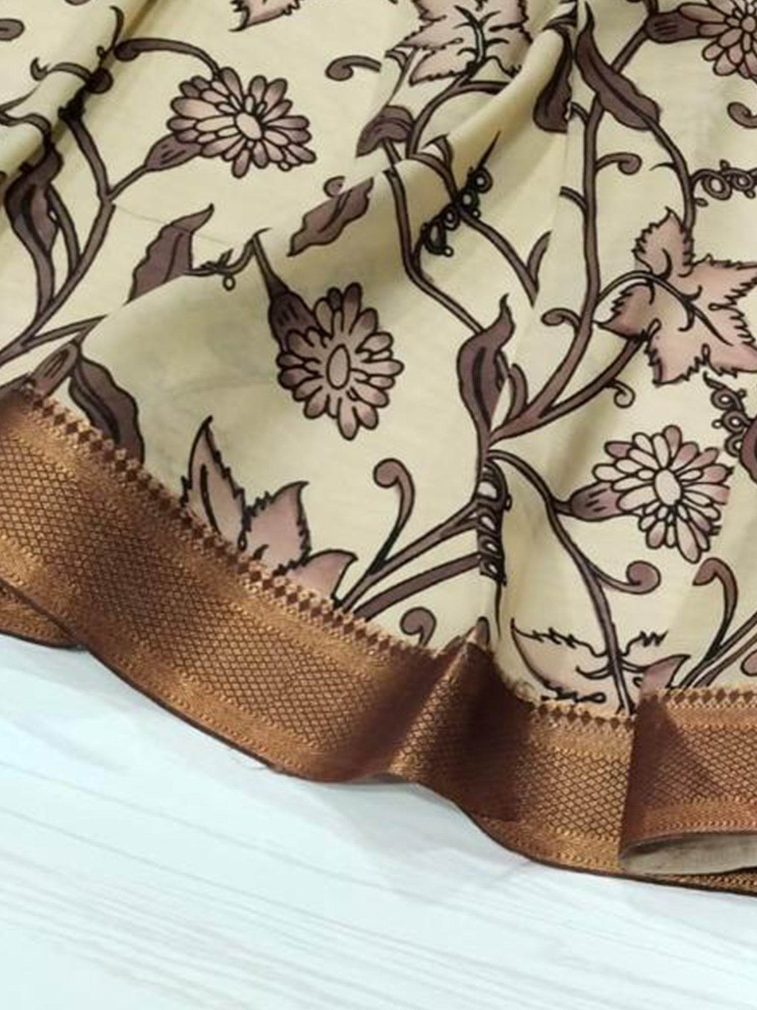 A brown hand-painted Kalamkari dupatta with intricate designs from Mrida.