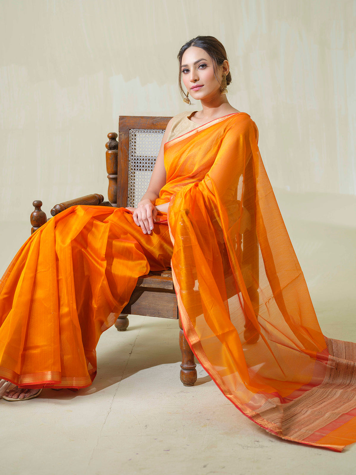 Saffron Maheshwari cotton silk saree with jute work pallu.