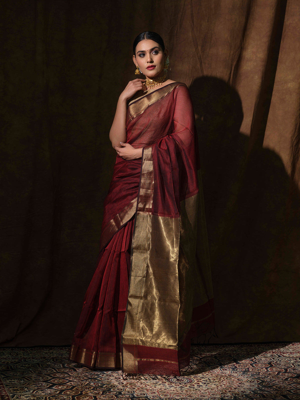 Maroon Maheshwari cotton silk saree with shimmering bronze accents.