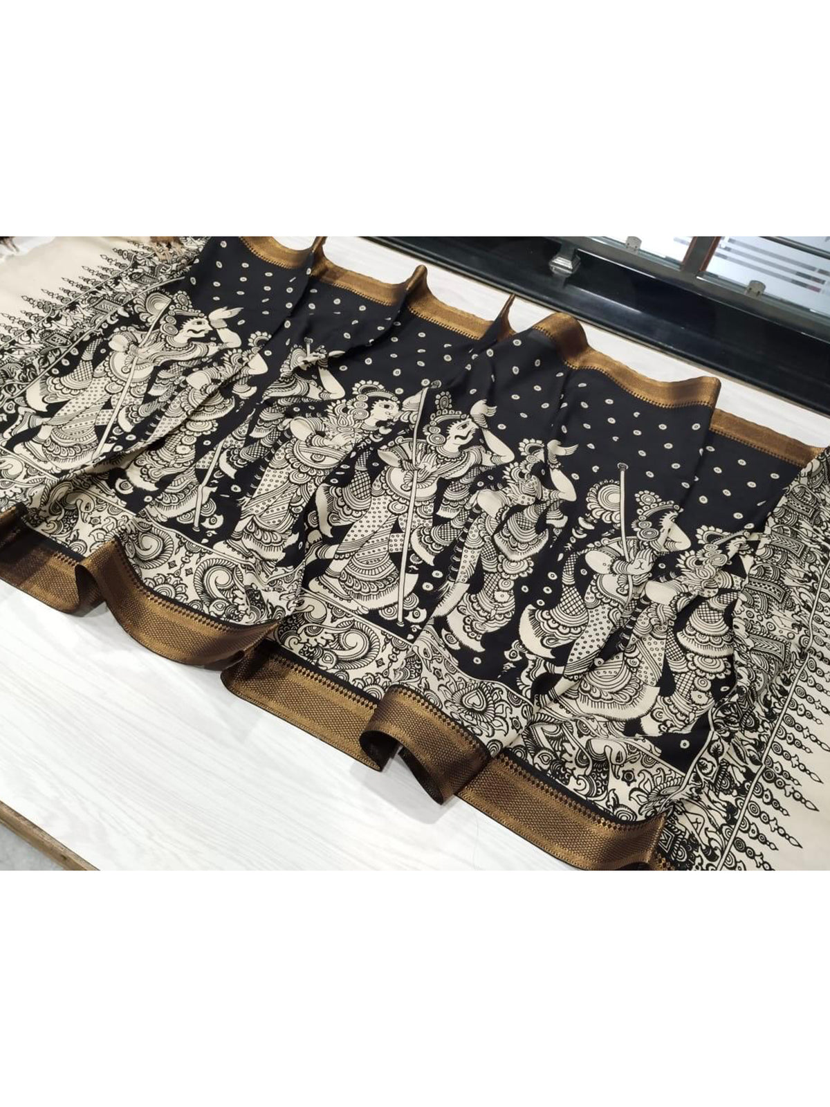 A black hand-painted Kalamkari dupatta with intricate details from Mrida.