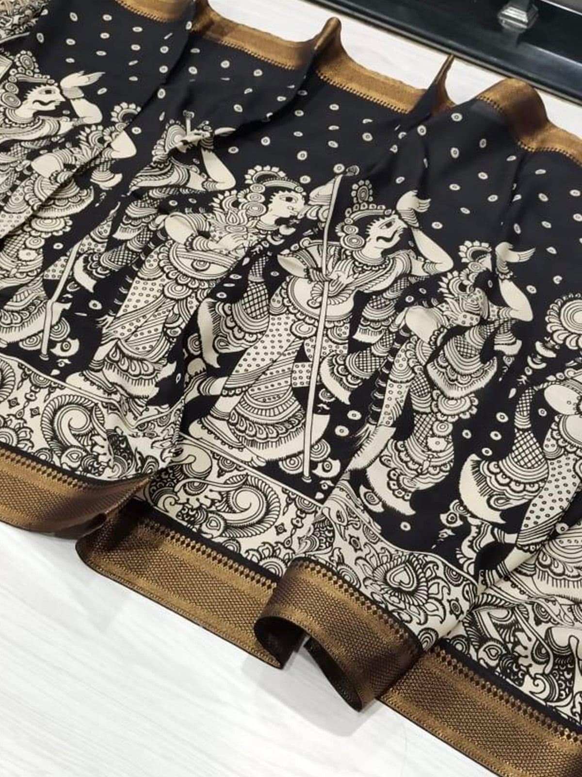 A black hand-painted Kalamkari dupatta with intricate details from Mrida.