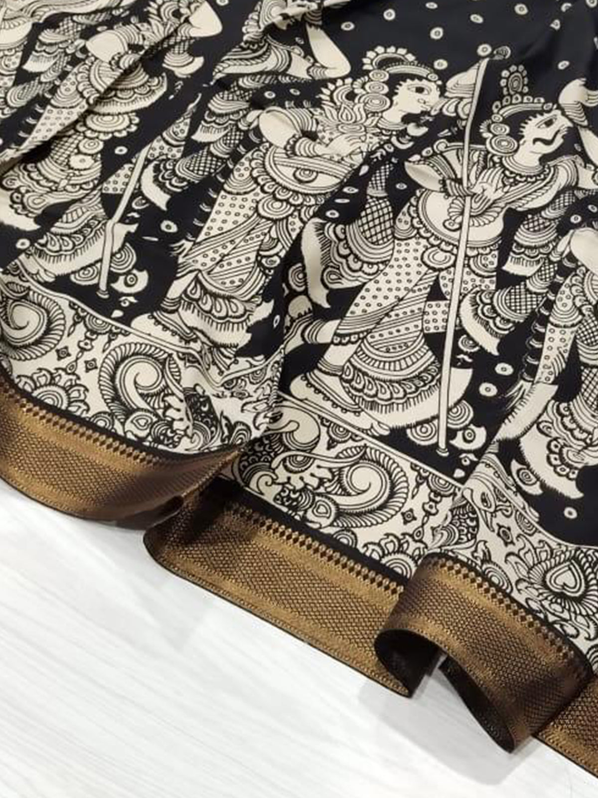 A black hand-painted Kalamkari dupatta with intricate details from Mrida.