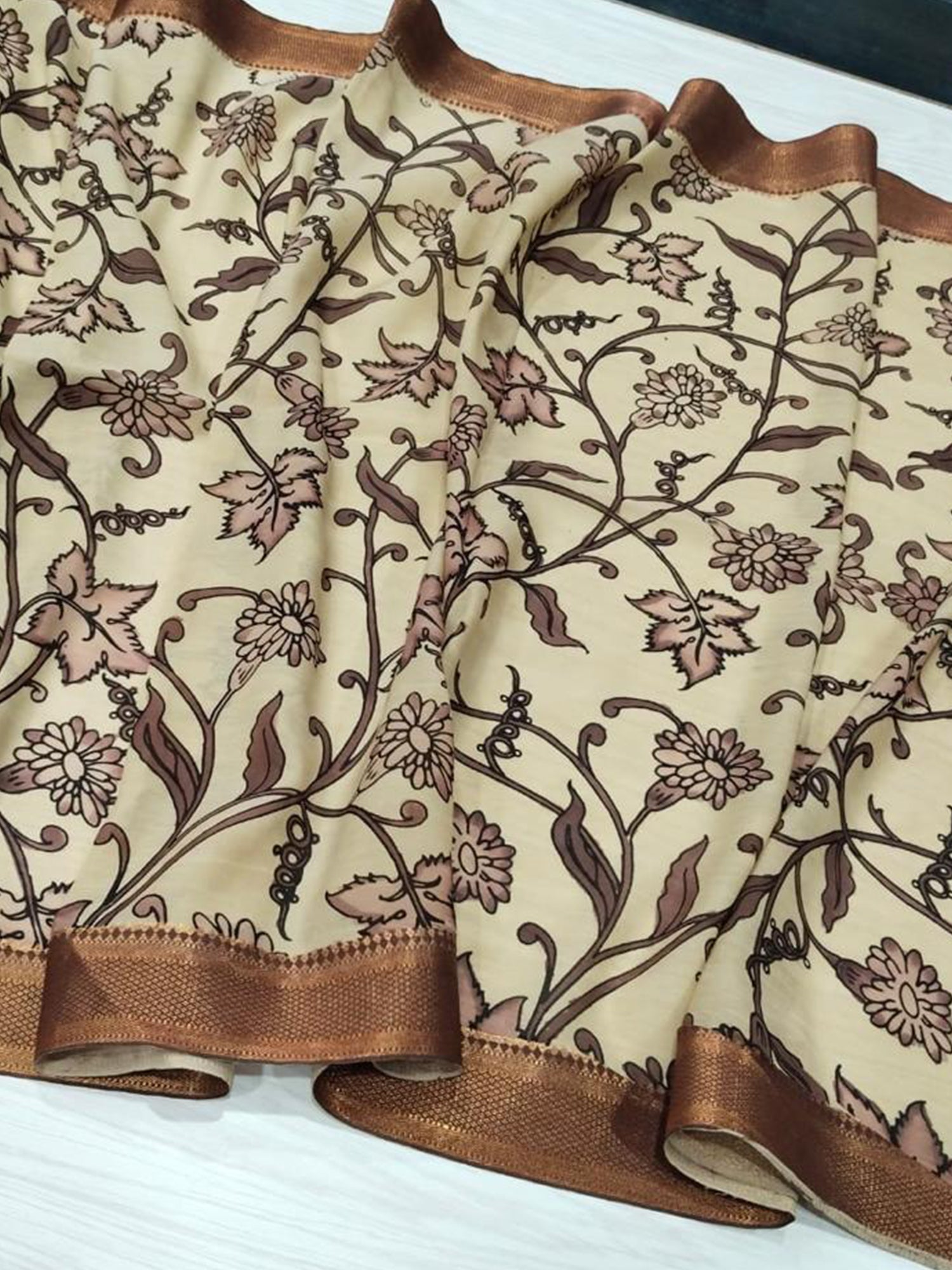 A brown hand-painted Kalamkari dupatta with intricate designs from Mrida.