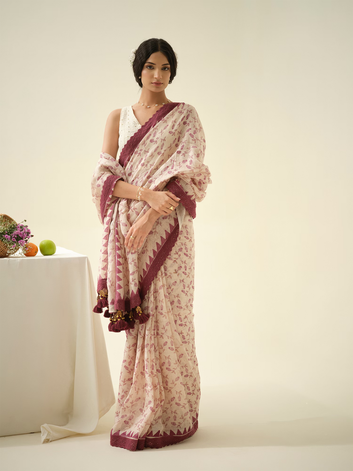 Woman wearing a floral saree with a white background