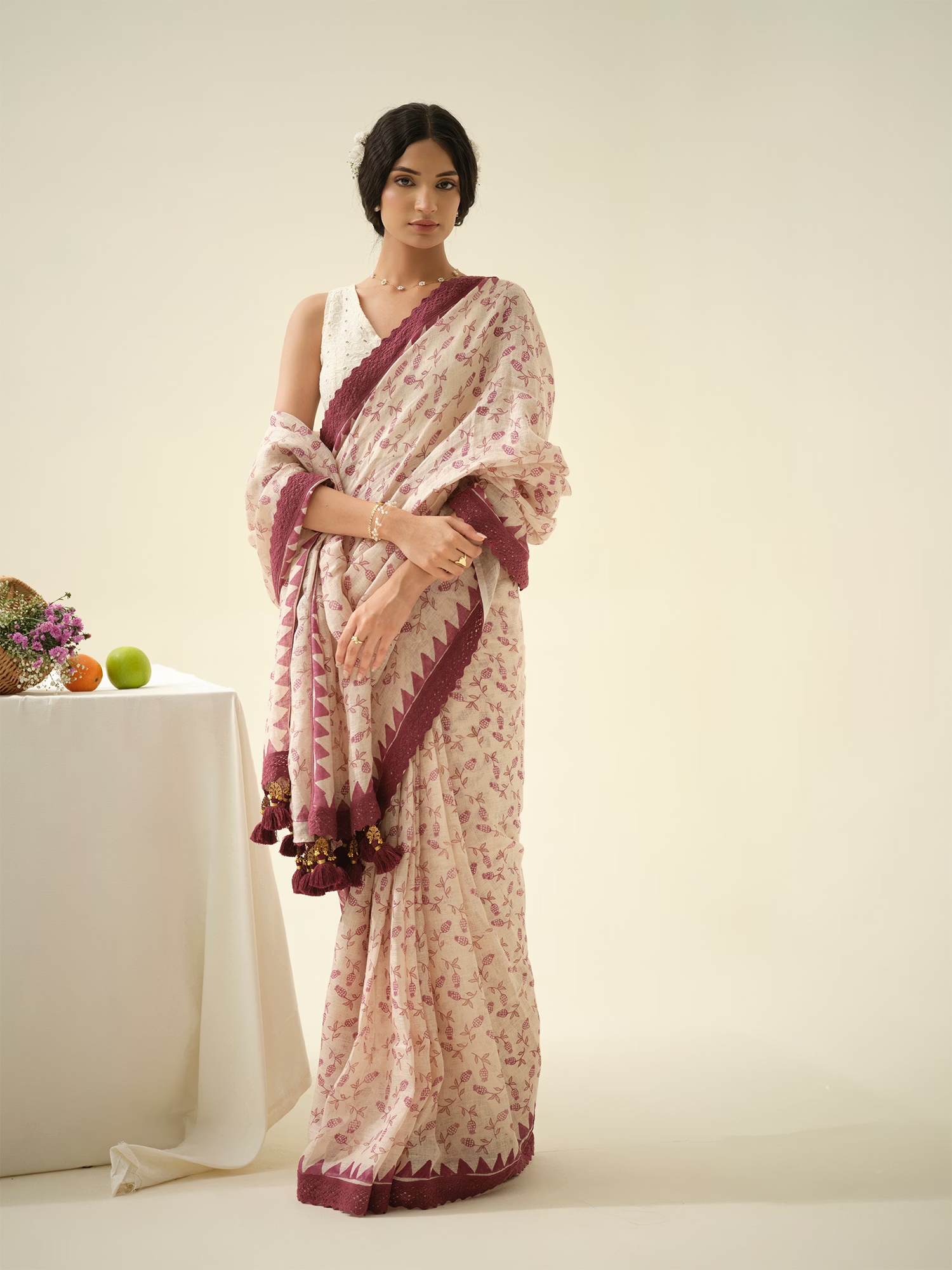 Woman wearing a floral saree with a white background
