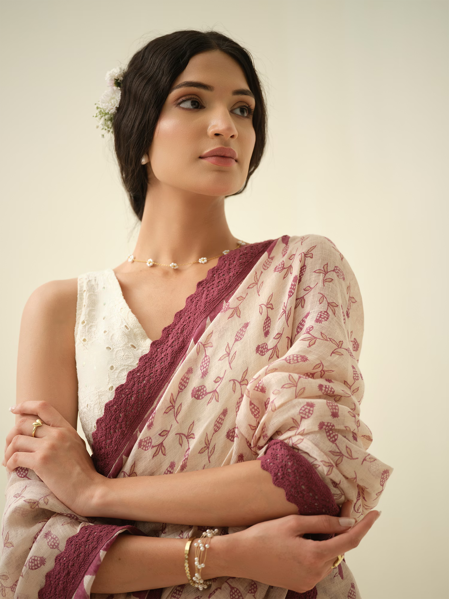 Woman wearing a Beige saree with a plain background