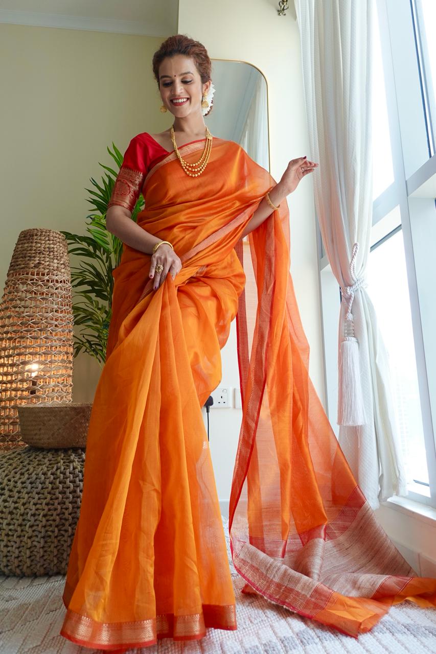 Saffron Maheshwari cotton silk saree with jute work pallu.