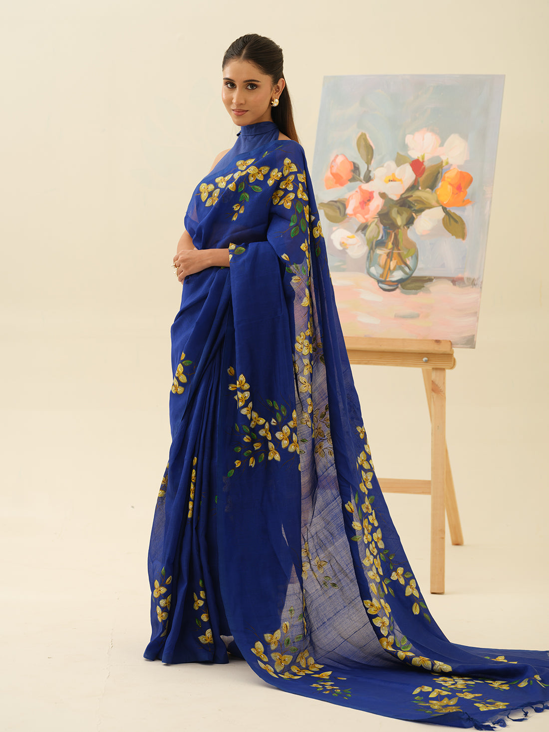 Bougainvillaea Wall handpainted saree by Mrida featuring yellow and white floral motifs on an indigo base