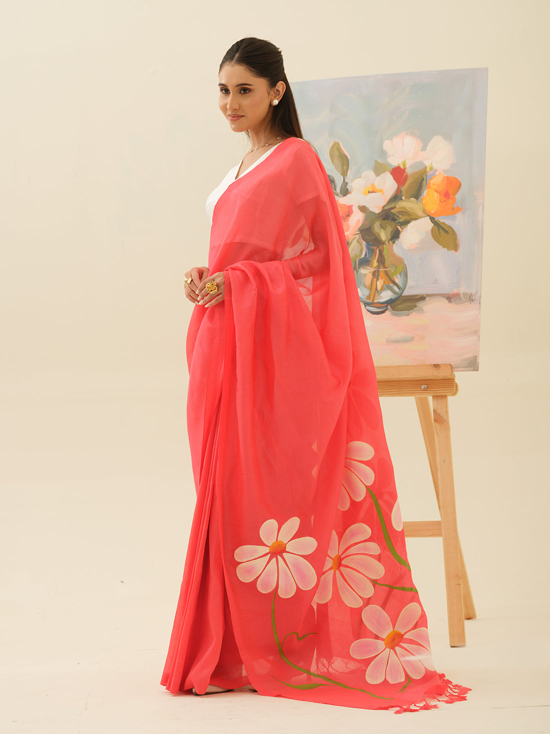 Champa Blush handpainted saree by Mrida featuring white champa flowers on a coral base