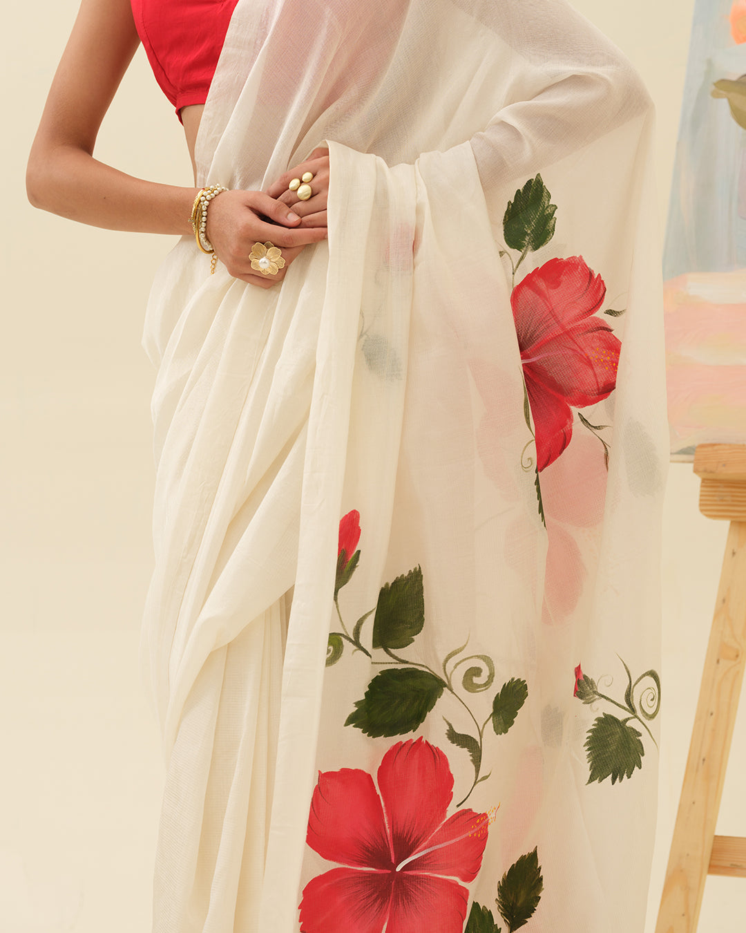 Close-up of handpainted red hibiscus floral artwork on the Crimson Hibiscus saree