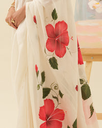 Artisan handpainted hibiscus motifs on the Crimson Hibiscus saree by Mrida