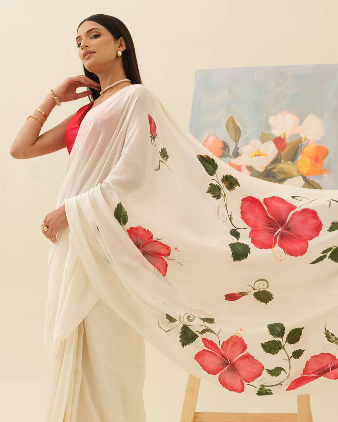 Detail view of crimson red hibiscus blooms on the ivory saree by Mrida