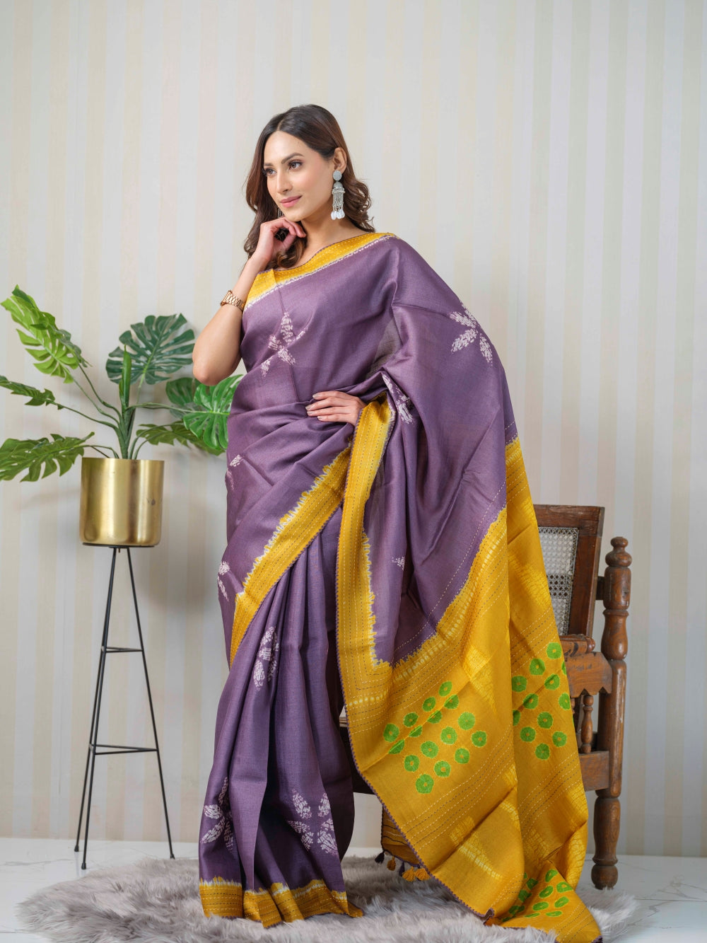 An Indian women wearing a  Premium Handloom Shibori Tussar Silk Maheshwari saree in Mauve & Mustard, by Mrida